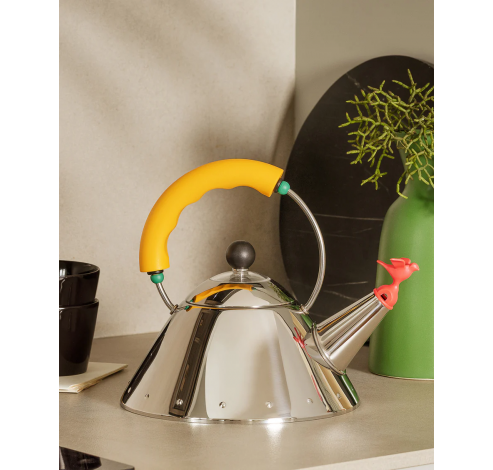 Kettle in 18/10 stainless steel mirror polished with handle and small bird-shaped whistle in PA, yellow. Magnetic steel bottom suitable for induction cooking.  Alessi